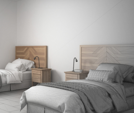 zwei dekorierte Einzelbetten mit Holzkopfteil und Nachttischen