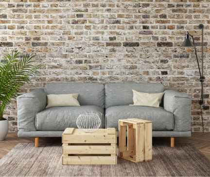 graues Zweisitzer Sofa vor Steinwand